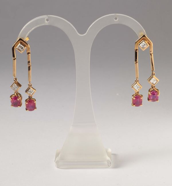 A pair of ruby and princess-cut diamond earrings