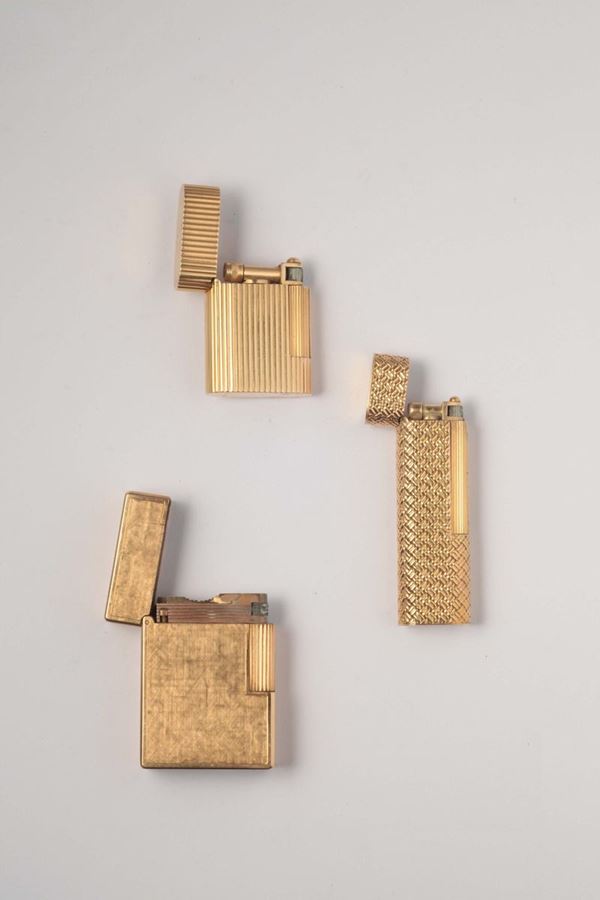 A three gold lighter boxes. By Van Cleef & Arpels and Dupont