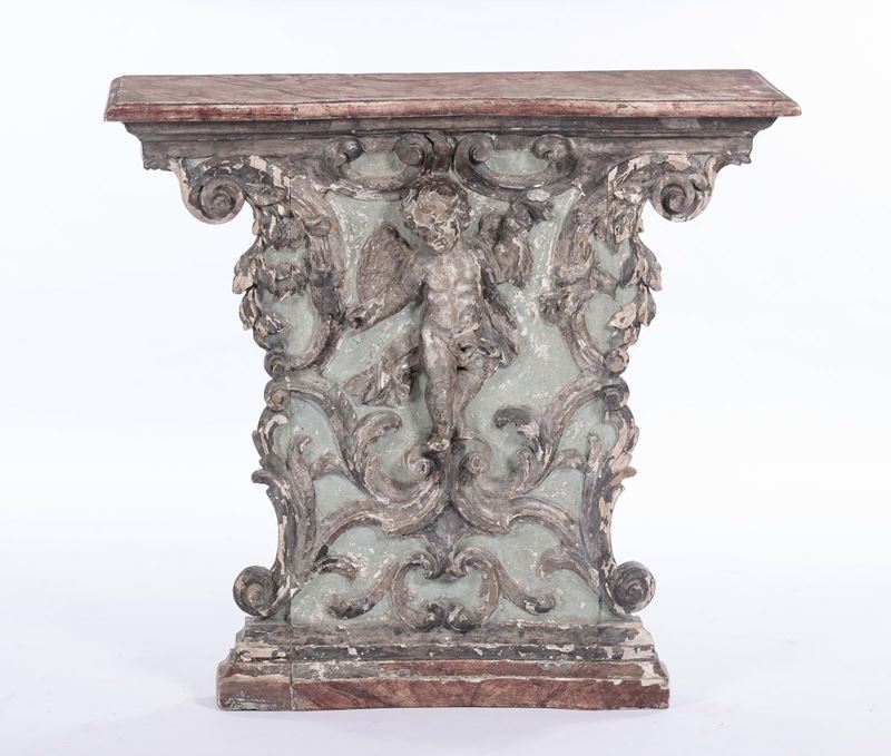 Consolina in legno con fronte intagliato con putto, XVIII secolo  - Asta Arredi e Oggetti d'Arte da Importanti Collezioni Private - Cambi Casa d'Aste