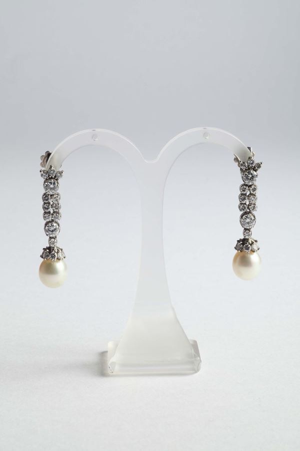 A pair of cultured pearls and diamonds earrings