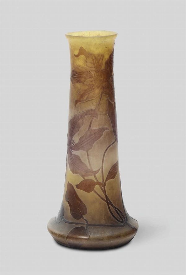 Emile Gallé, Nancy, France, 1900 ca. A truncated cone-shaped glass vase with a decor in relief of flowers and leaves
