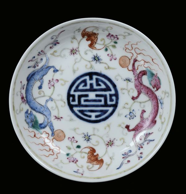 A small polychrome porcelain dish with imaginary decoration, China, Qing Dynasty, Guangxu (1875-1908) mark and the period