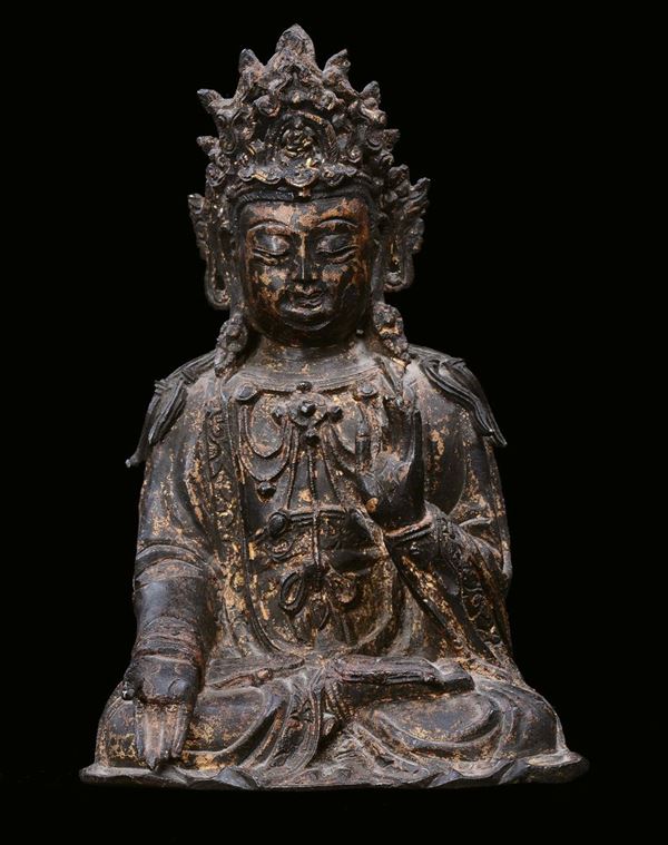 A bronze sitting Guanyin with gilt traces, China, Ming Dynasty, 17th century