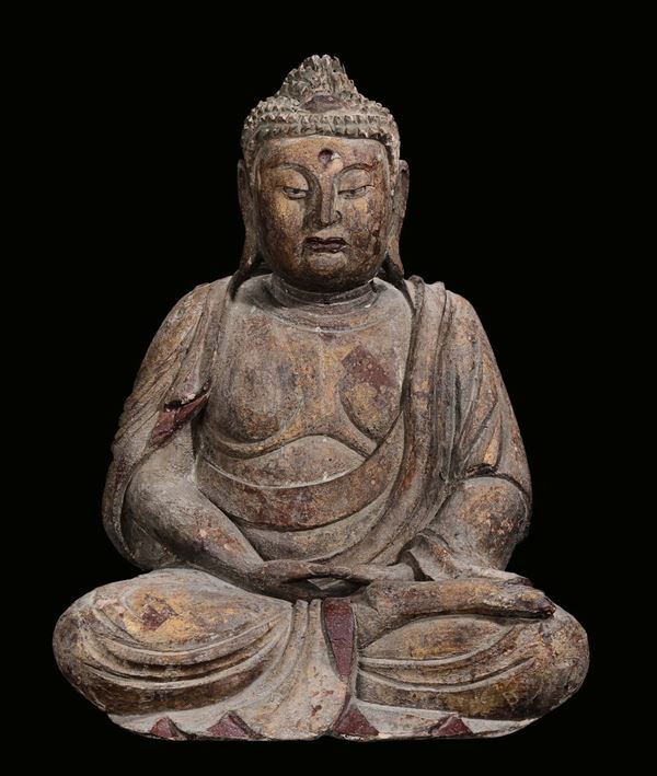 A monochrome carved wood sitting Buddha, China, Ming Dynasty, 17th century