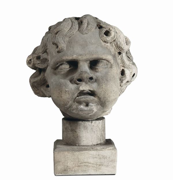 Due testine maschili scolpite in pietra