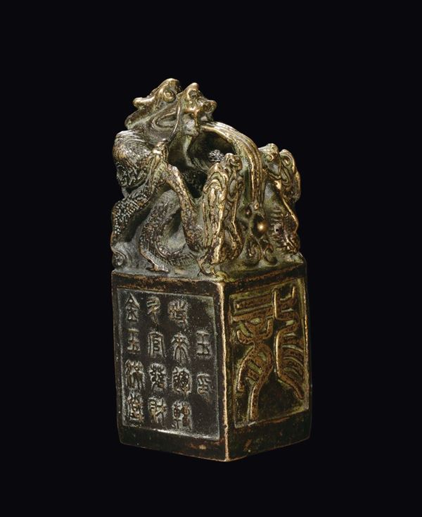 A bronze Chinese seal with square base with engraving and Pho dog on the top, China, Ming Dynasty, 17th century