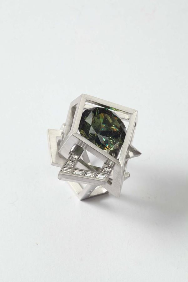 A baguettes diamonds and demantoid garnet ring. By Enrico Cirio, Italy. Demantoid garnet weighing ct.15,974.