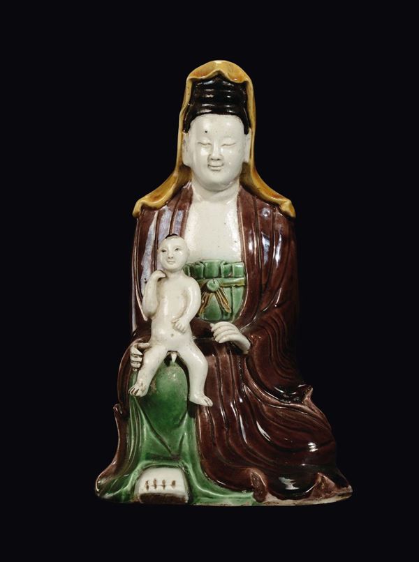 A polychrome porcelain Guanyin and child, China, Qing Dynasty, Kangxi period (1662-1722)