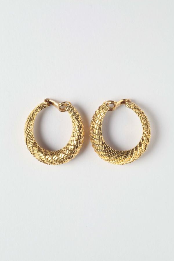 A pair of gold earrings. Signed Boucheron