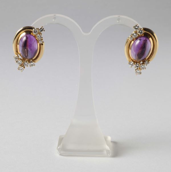 A pair of cabochon amethyst and diamonds earrings