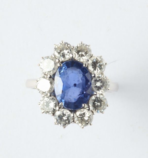 A sapphire and diamonds ring. The sapphire, weights ct.4,50 circa. No indications of heating (NTE)
