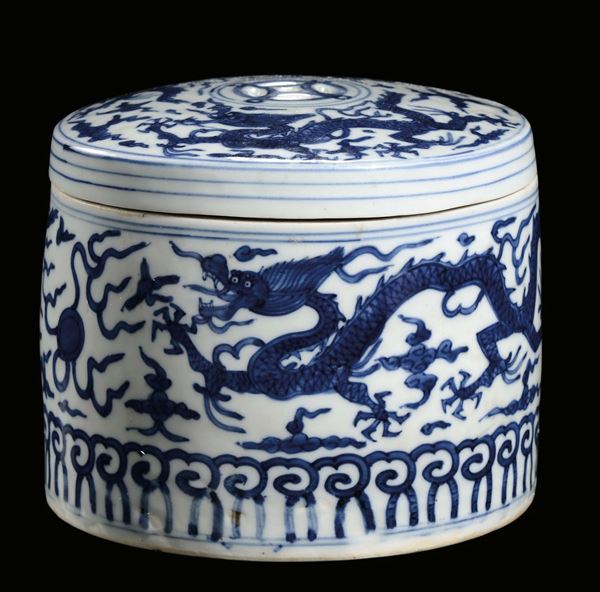 A round white and blue porcelain box with band and cover decorated with dragons, China, Ming Dynasty,  Jiajing (1522-1566) mark and the period
