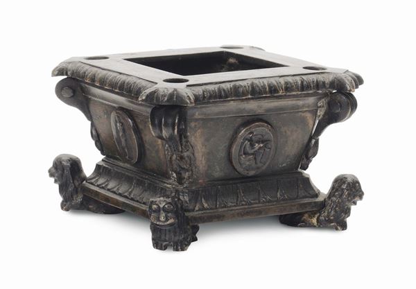 A quadrangular molten and chiselled bronze inkwell, caster of the 18th -19th century