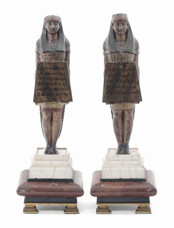 A pair of Egyptian figures in painted wood on marble and ivory bases, Italian or French sculptor of  [..]