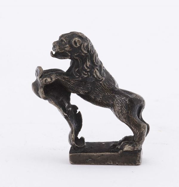 A molten and chiselled bronze lion figure holding a blazon, Venetian or German art, 17th -18th century