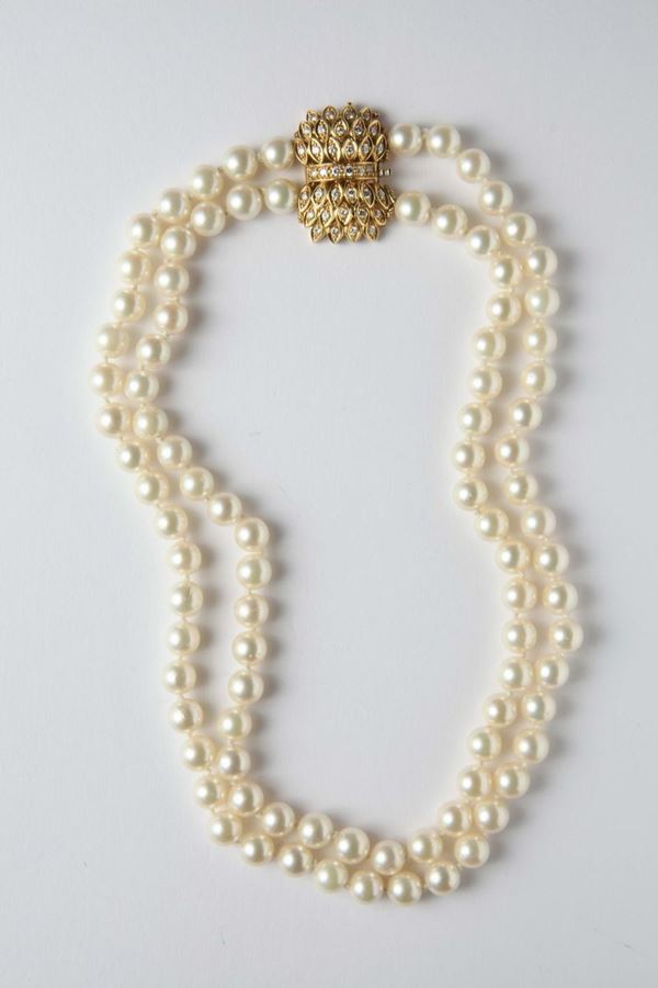 A double-row of cultured pearl necklace with a gold and diamond clasp