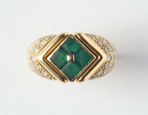 An emerald and gold ring. Signed Bulgari