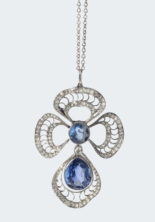 A 20th century pendent with two sapphire, old-cut diamond and platinum. The sapphires weighing ct 9,90-2,95 circa. No indication of heating (NTE)
