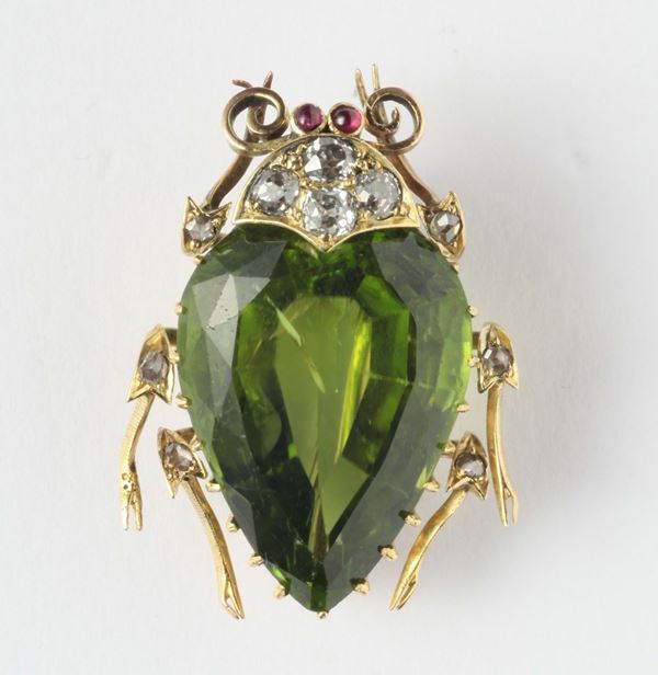 A peridot, diamonds and gold brooch