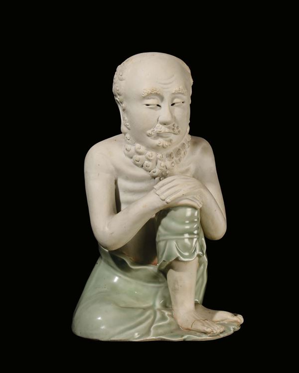 A porcelain “sitting man” sculpture, China, Qing Dynasty, 18th century