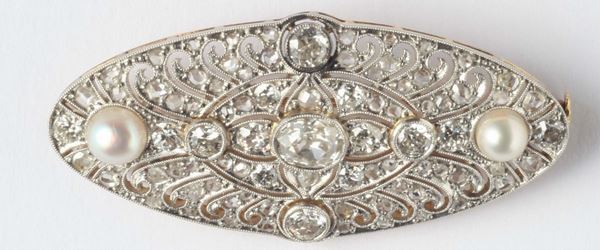 An Art Nouveau platinum, natural pearl and diamond brooch