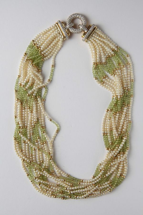 A peridot and cultured pearl necklace with a diamond clasp