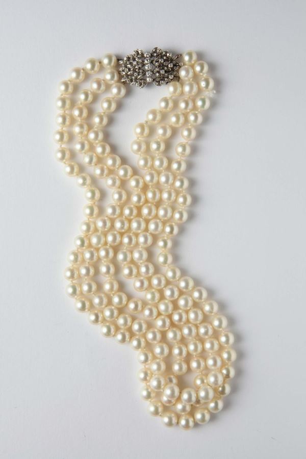 A three-row of Akoya pearls necklace with an old-cut diamond clasp