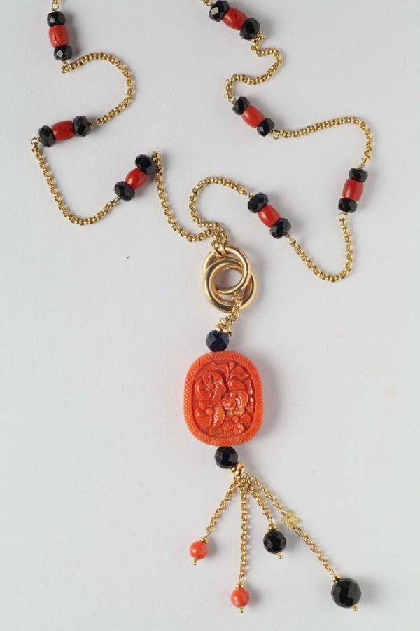 A gold, onix and engraved coral necklace