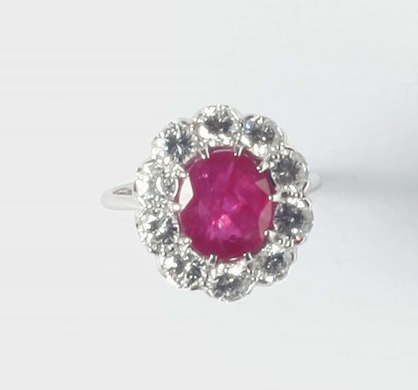 A ruby and diamond cluster ring. The ruby weighing ct 3,90 circa. No indication of heating (NTE)