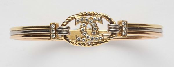 A diamond and gold bangle. Signed Cartier London