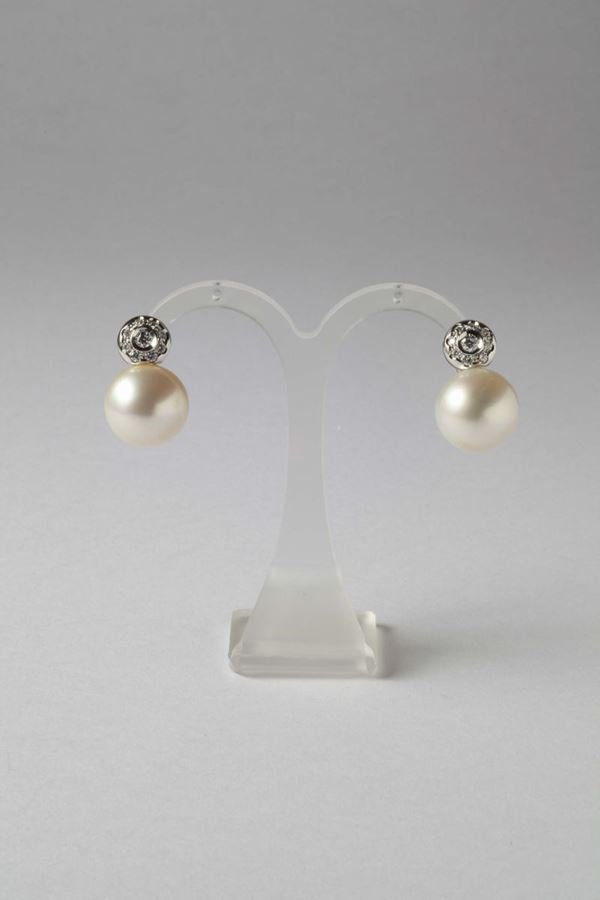 A pair of cultured pearl and diamond earrings