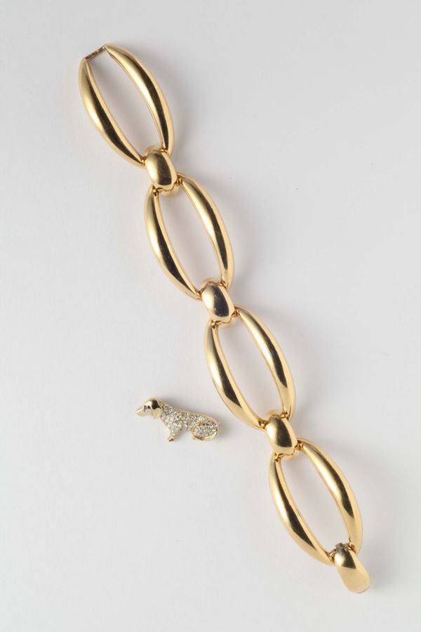 A gold bracelet with a diamond brooch