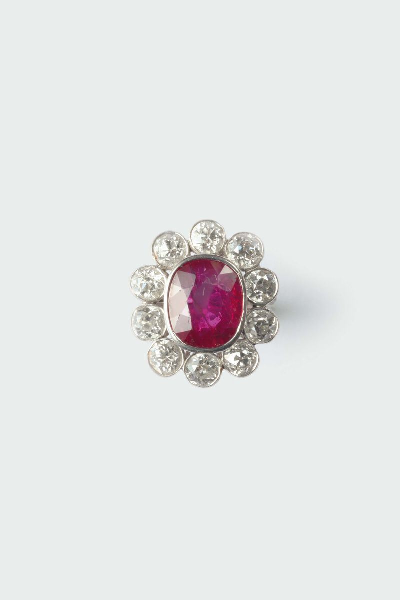 A ruby and diamond cluster ring. The ruby weighing ct 5,00 circa. No indicationf of heating (NTE)  - Auction Silver, Watches, Antique and Contemporary Jewelry - Cambi Casa d'Aste