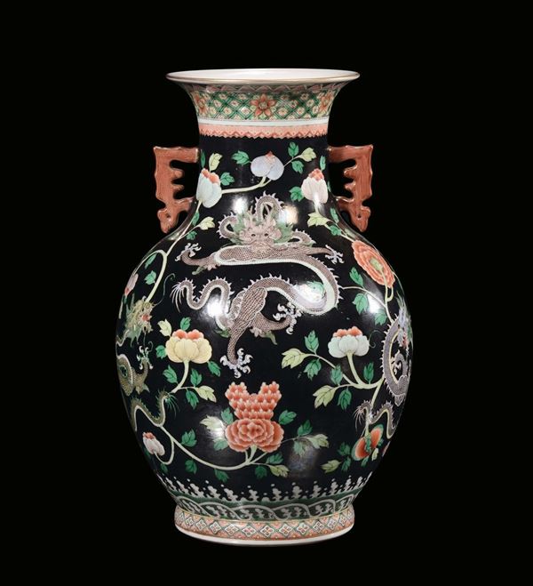 A polycrhome porcelain vase on black background with dragons, China, Qing Dynasty, 19th century