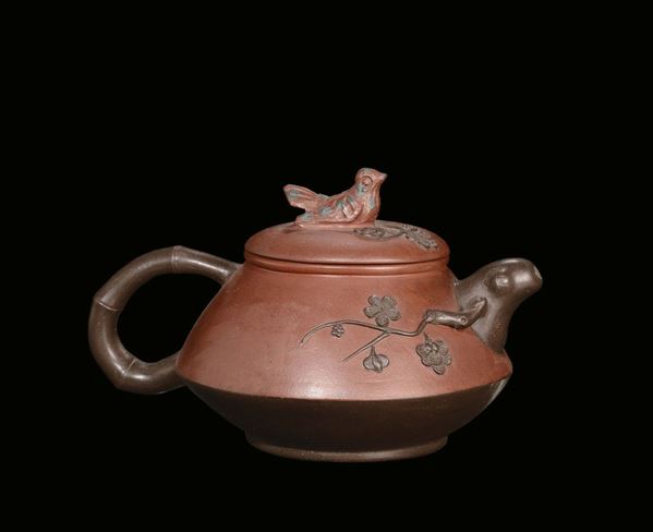 A stoneware Yinxing teapot with reliefs and “dove” cover holder, China, Republic, 20th century