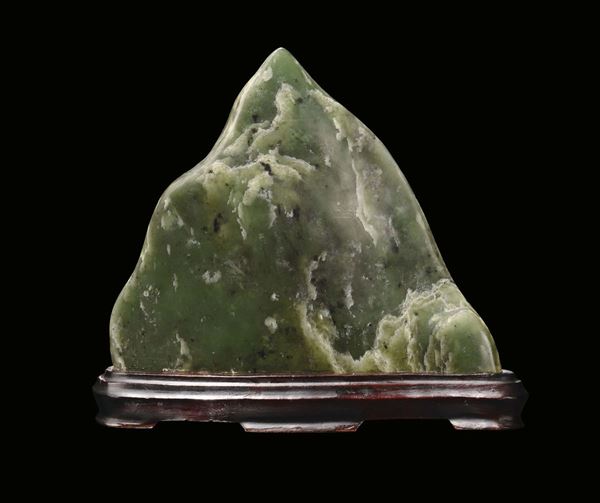 A spinach-green jade mountain with naturalistic shape, China, Qing Dynasty, 19th century
