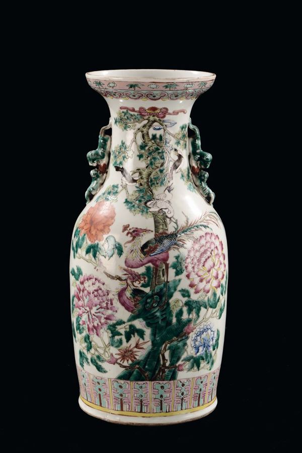 A polychrome porcelain vase with peacocks and flowers, China, Qing Dynasty, 19th century
