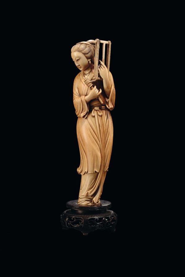 A carved ivory figure of spinster, China, Qing Dynasty, 19th century