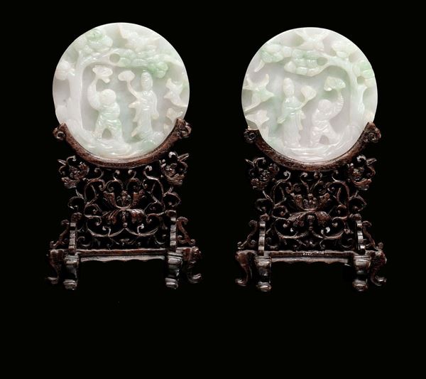 A pair of circular jadeite plates on a fret-worked wooden support, China, Qing Dynasty, 19th century