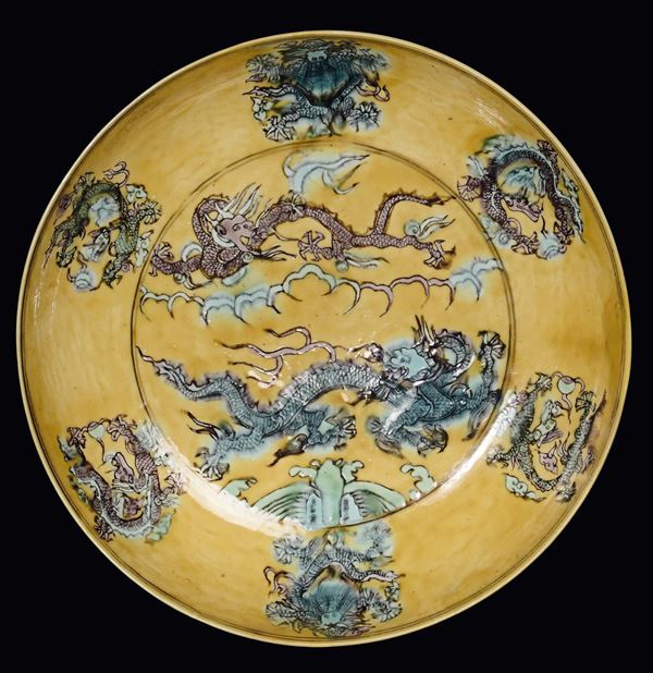 A porcelain dish with yellow background with green and brown monochrome dragons, China, Wanli (1563-1629) mark and the Period