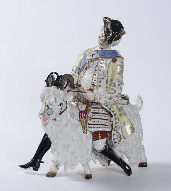Statuina in porcellana raffigurante figura maschile in sella ad un caprone