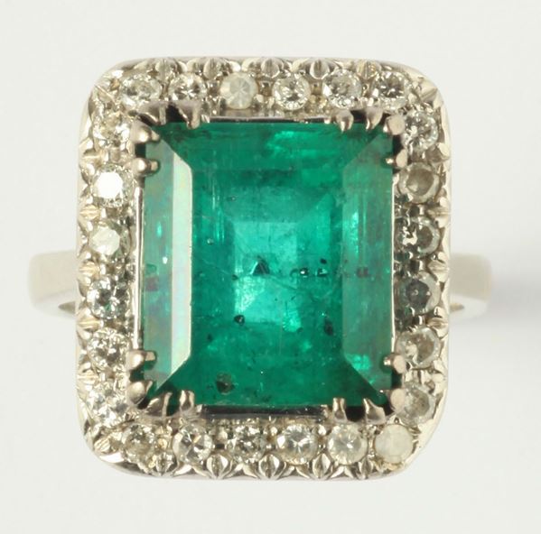 An emerald and diamond ring. The emerald weigh ct 7,15