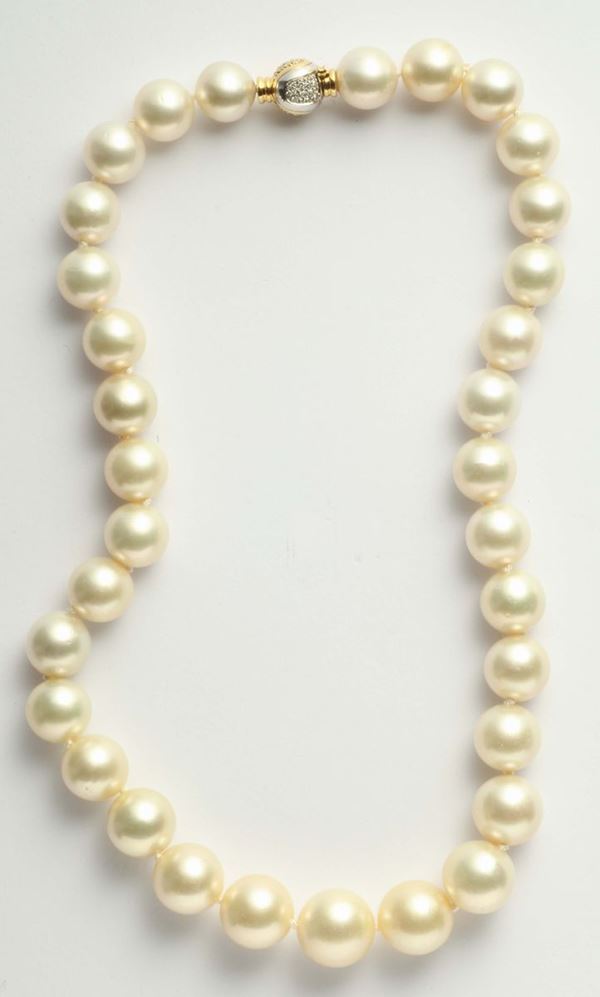 A south sea pearl necklace. A gold and diamond clasp