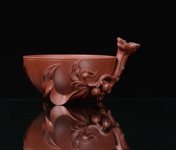 A red stoneware bowl with peach branch in relief, signed Shengsi, China, Republic, 20th century