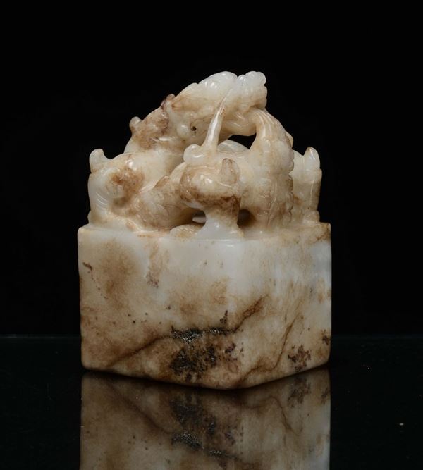 A white jade with russet dragon paperweight, China, early 20th century