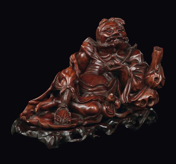 A wood carving with lying dignitary, China, Republic, 20th century