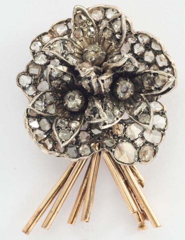 A rose cut diamond silver and gold flower brooch