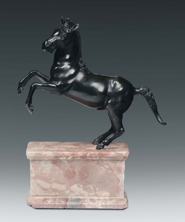 A molten and chiselled bronze rampant horse, Italian or Flemish artist, 17th century on coloured marble base