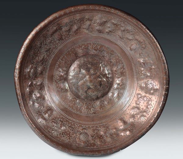 A large embossed and chiselled copper concave basin, northern Italian art, 17th-18th century