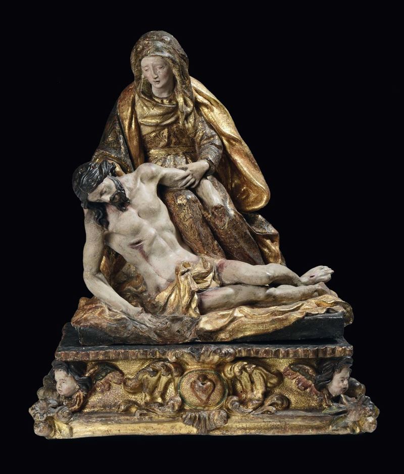 A polychrome and gilt earthenware Pity on rectangular base with angels’ heads and volutes, Spanish sculptor, 16th - 17th century, circle of Juan Martines Montanes (Jaen 1568 - Siviglia 1650)  - Auction Sculpture and Works of Art - Cambi Casa d'Aste